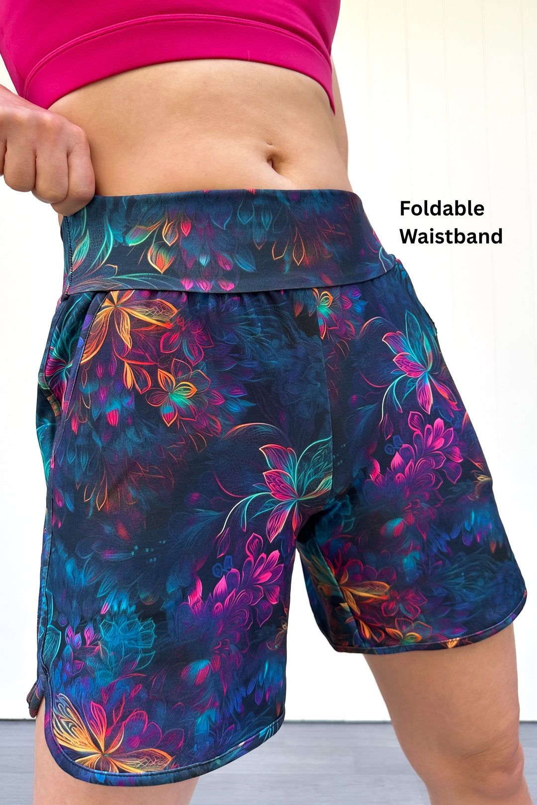 Floral-patterned shorts with a foldable waistband on a plain background