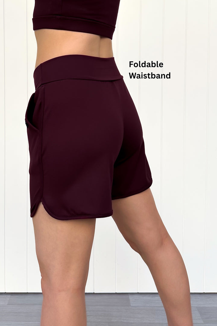 Maroon shorts with a foldable waistband on a white background